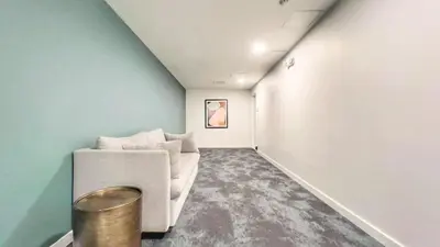a living room with a white couch and blue walls at Fabulous Urban Retreat in San Diego in San Diego