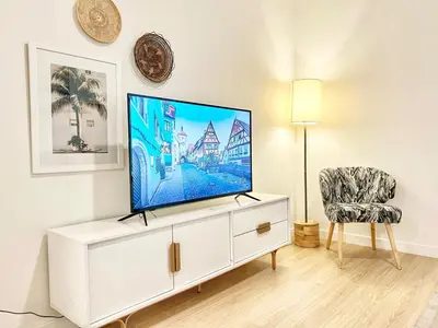 a flat screen tv on a white cabinet in a living room at Fabulous Urban Retreat in San Diego in San Diego