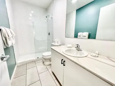 a bathroom with a sink and a toilet and a mirror at Fabulous Urban Retreat in San Diego in San Diego