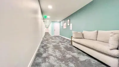 a living room with a couch and a wall at Grand Downtown San Diego Apartment in San Diego