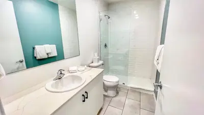 a bathroom with a sink and a toilet and a shower at Grand Downtown San Diego Apartment in San Diego