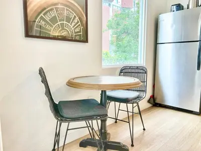 a kitchen with a table and two chairs and a refrigerator at Grand Downtown San Diego Apartment in San Diego