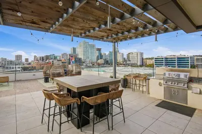 an outdoor kitchen with a view of a city skyline at The Leo - Unit 602 in San Diego