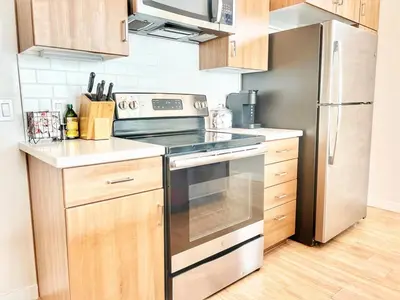 a kitchen with a stove and a refrigerator at 3 Bedroom Penthouse in Downtown! in San Diego