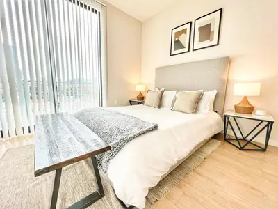 a bedroom with a large bed and a large window at 3 Bedroom Penthouse in Downtown! in San Diego