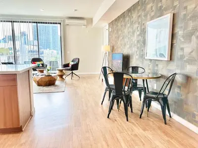 a living room with a table and chairs in it at 3 Bedroom Penthouse in Downtown! in San Diego