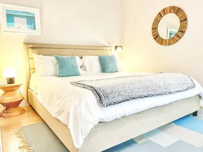 a bedroom with a large bed with a mirror on the wall at The Leo - One Bedroom Apartment w Private Balcony in San Diego
