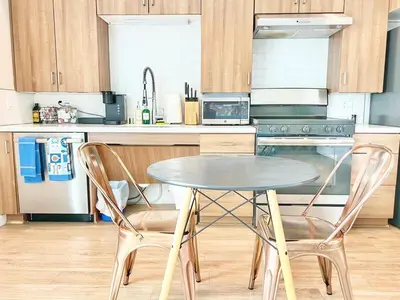 a kitchen with a table and two chairs at The Leo - One Bedroom Apartment w Private Balcony in San Diego