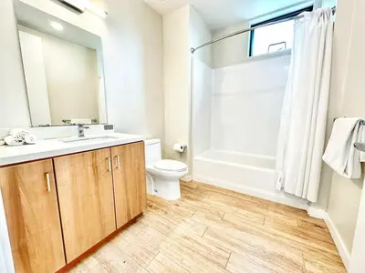a bathroom with a sink and a toilet and a shower at One Bedroom Apartment wBalcony and City Views! in San Diego