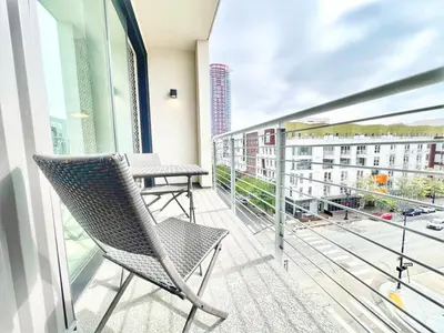 a balcony with a chair and a table at Skyline Flat Facing Downtown San Diego in San Diego