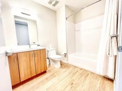 a bathroom with a toilet and a sink and a shower at Skyline Flat Facing Downtown San Diego in San Diego