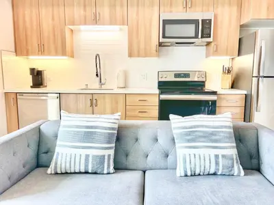 a couch with two pillows on it in a kitchen at Sunset Stay in Downtown San Diego in San Diego
