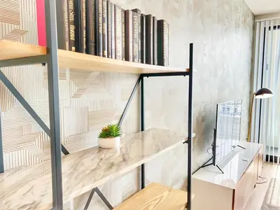 a home office with a desk and bookshelves at City View Apartment in Downtown in San Diego