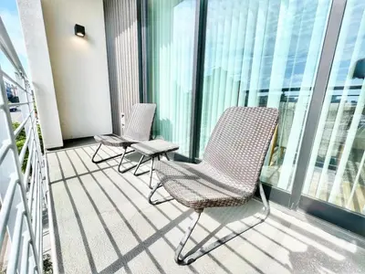 two chairs sitting on the balcony of a building at City View Apartment in Downtown in San Diego