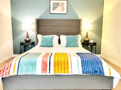 a bedroom with a bed with a colorful striped blanket at City View Apartment in Downtown in San Diego