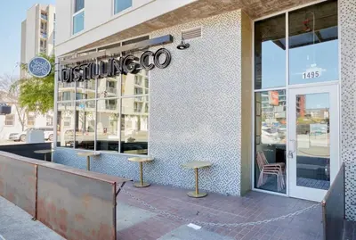 a store with two stools in front of a building at City View Apartment in Downtown! in San Diego