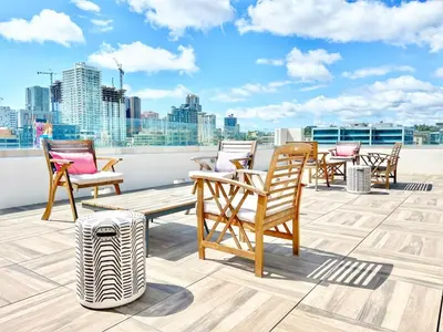 a group of chairs on the roof of a building at City View Apartment in Downtown! in San Diego