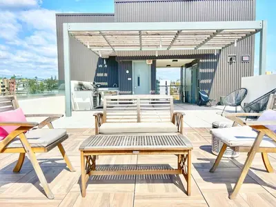 a patio with benches and chairs on a building at City View Apartment in Downtown! in San Diego