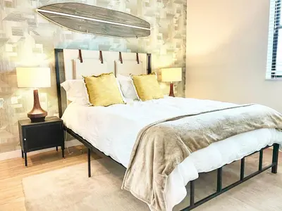 a bedroom with a large bed with yellow pillows at San Diego Skyline - Downtown Apartment in San Diego