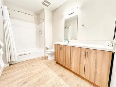 a bathroom with a sink and a toilet and a mirror at The Executive Getaway in San Diego