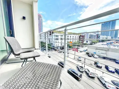 a chair on a balcony with a view of a city at The Executive Getaway in San Diego