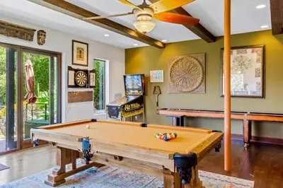 a pool table in a living room with a ceiling fan at Casa Real | House in La Jolla in San Diego