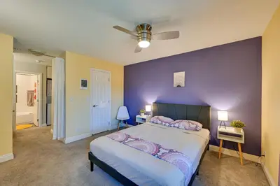 a bedroom with a large bed with a purple wall at Quiet San Diego Condo with Balcony, Pool and Hot Tub! in San Diego
