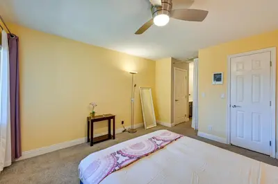 a bedroom with a bed and a ceiling fan at Quiet San Diego Condo with Balcony, Pool and Hot Tub! in San Diego