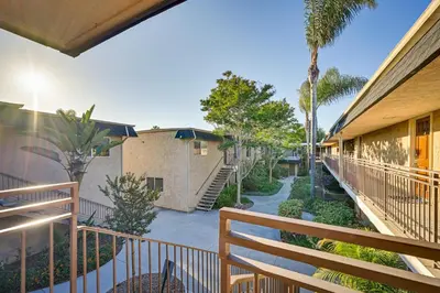 a balcony of a building with trees and a sidewalk at Quiet San Diego Condo with Balcony, Pool and Hot Tub! in San Diego