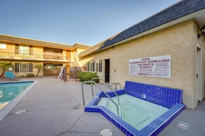 a swimming pool in front of a building at Quiet San Diego Condo with Balcony, Pool and Hot Tub! in San Diego