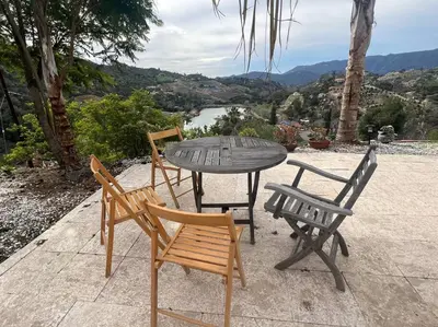 a table and four chairs and a table and a table and chairs at The most breathtaking Lake and Mountain View in Fallbrook