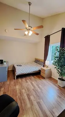 a bedroom with a bed and a ceiling fan at -Vacation-Top corner 2-story one bedroom La Jolla Condo in San Diego