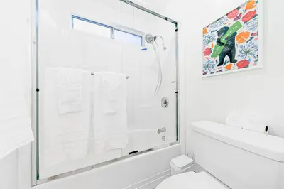 a white bathroom with a shower and a sink at Newport Beach Simplicity III in Newport Beach