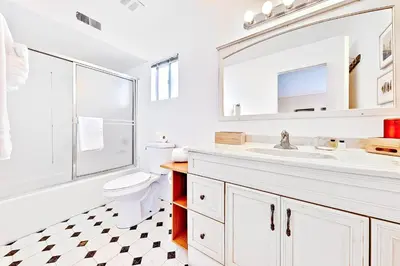 a bathroom with a sink and a toilet and a mirror at Newport Beach Simplicity III in Newport Beach