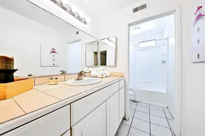 a bathroom with a sink and a mirror at Newport Beach Simplicity III in Newport Beach