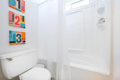 a bathroom with a white toilet and a shower at Newport Beach Simplicity III in Newport Beach