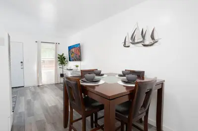 a dining room with a wooden table and chairs at Seaside Point Loma Home with Outdoor Patio in San Diego