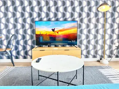 a living room with a tv and a table at The Traveler's Getaway in San Diego