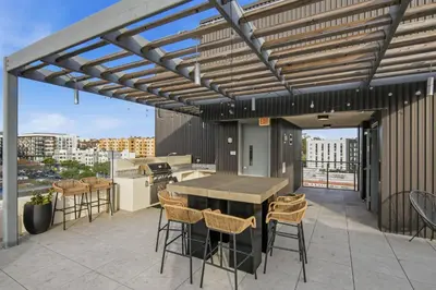 a patio with a table and chairs on a roof at The Traveler's Getaway in San Diego