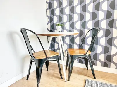 a table and two chairs in a room with a wall at The Traveler's Getaway in San Diego