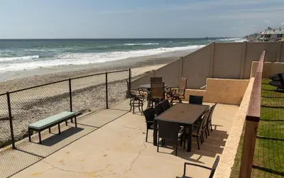a patio with a table and chairs and the beach at CB-2445A - Carlsbad Casa De Los Sueños | Unit A in Carlsbad