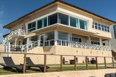 a large house with chairs in front of it at CB-2445A - Carlsbad Casa De Los Sueños | Unit A in Carlsbad