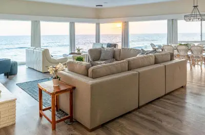 a living room with a large couch in front of the ocean at CB-2445A - Carlsbad Casa De Los Sueños | Unit A in Carlsbad