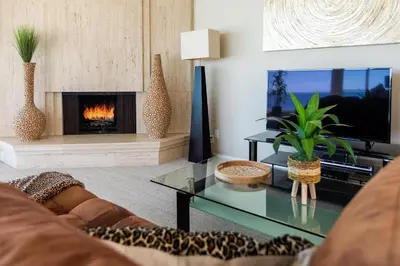 a living room with a couch and a fireplace at Unbeatable Location - Steps to Moonlight Beach in Encinitas