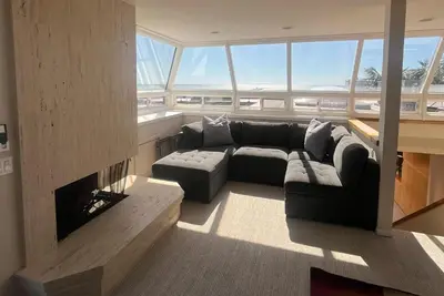a living room with a couch and a fireplace at Unbeatable Location - Steps to Moonlight Beach in Encinitas