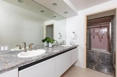 a bathroom with two sinks and a shower at Unbeatable Location - Steps to Moonlight Beach in Encinitas