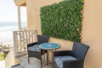 a patio with two chairs and a table and a hedge at CB-2445C - Carlsbad Casa De Los Sueños | Unit C in Carlsbad