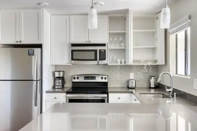 a white kitchen with a stove and a microwave at La Jolla 1br w gym wd pool nr bars shops SAN-8 in San Diego