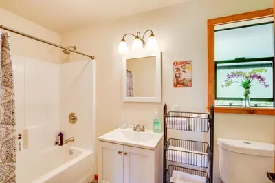 a bathroom with a sink and a toilet and a mirror at Julian Cottage Stay with Near Wildlife and Wineries in Julian