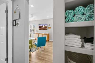 a room with a table and a blue chair at Beach-2-Bay 2br - Beach - AC - Patio in San Diego
